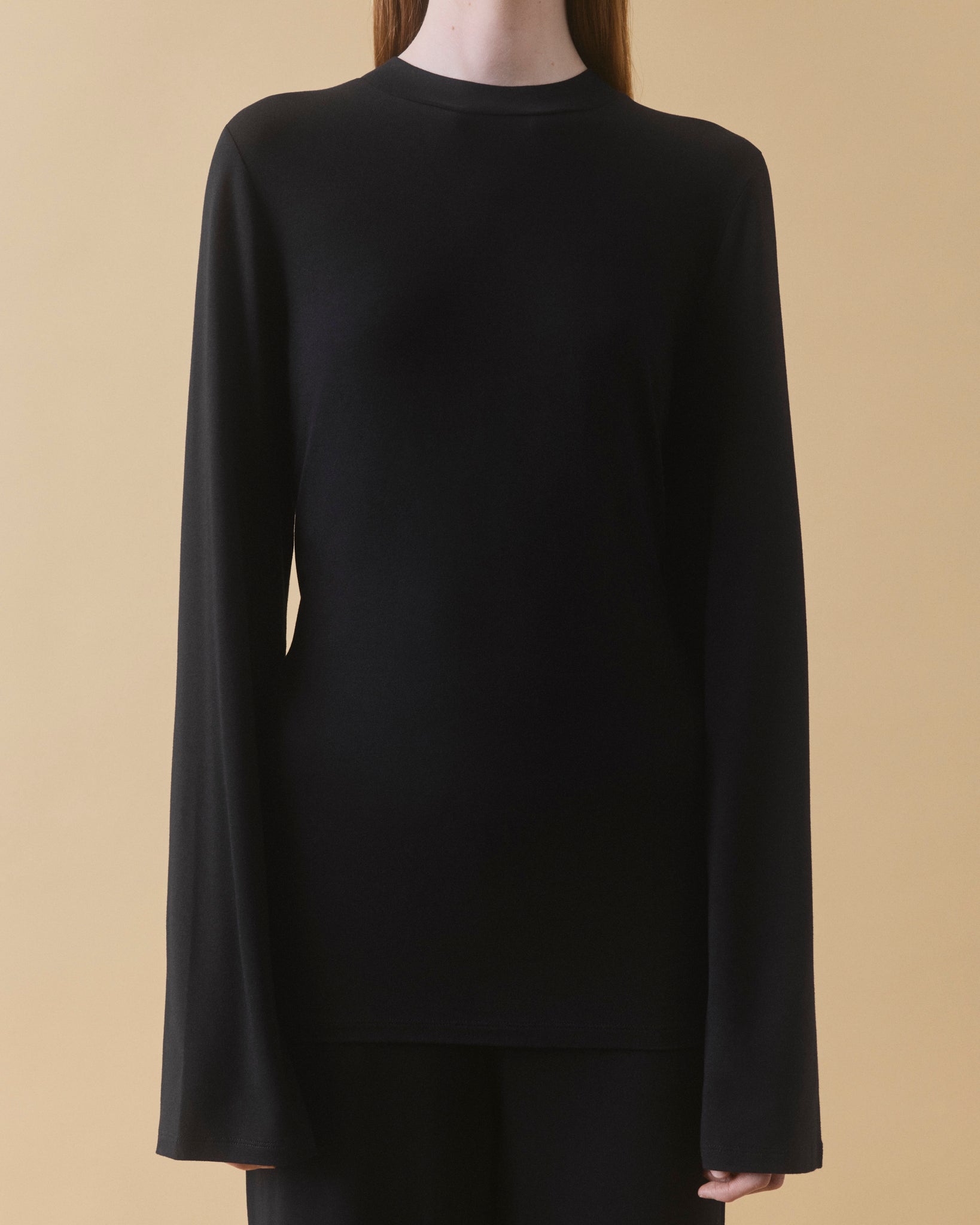 Black viscose long sleeve top with high neck and piped trim, front view – Dhoemi